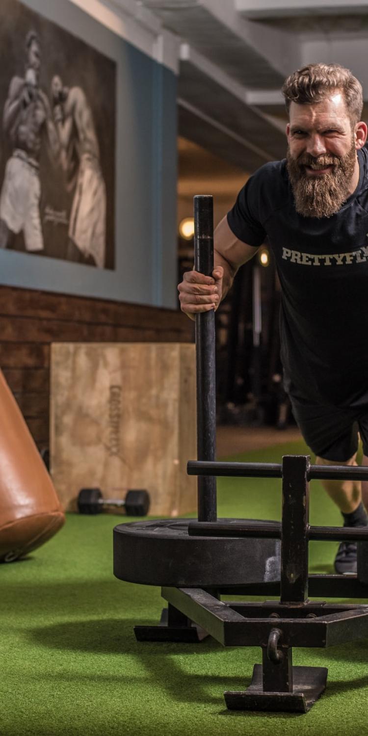 Man pushing a weight sled