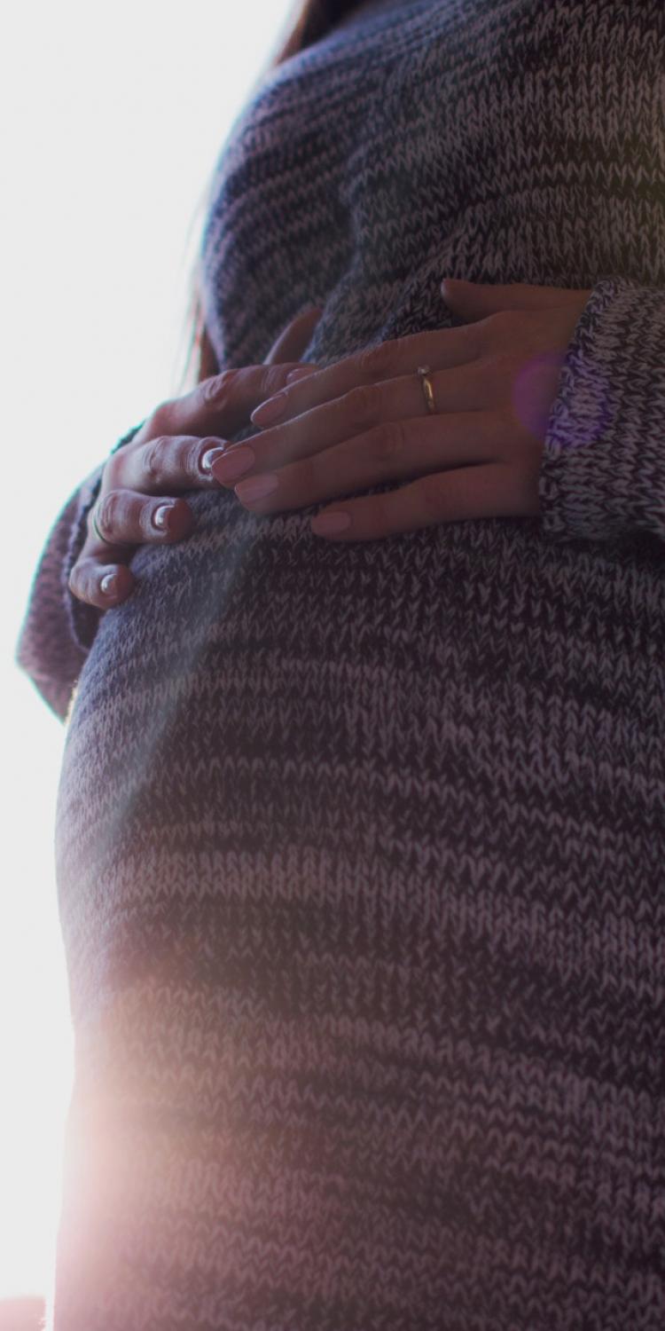 Pregnant woman holding belly