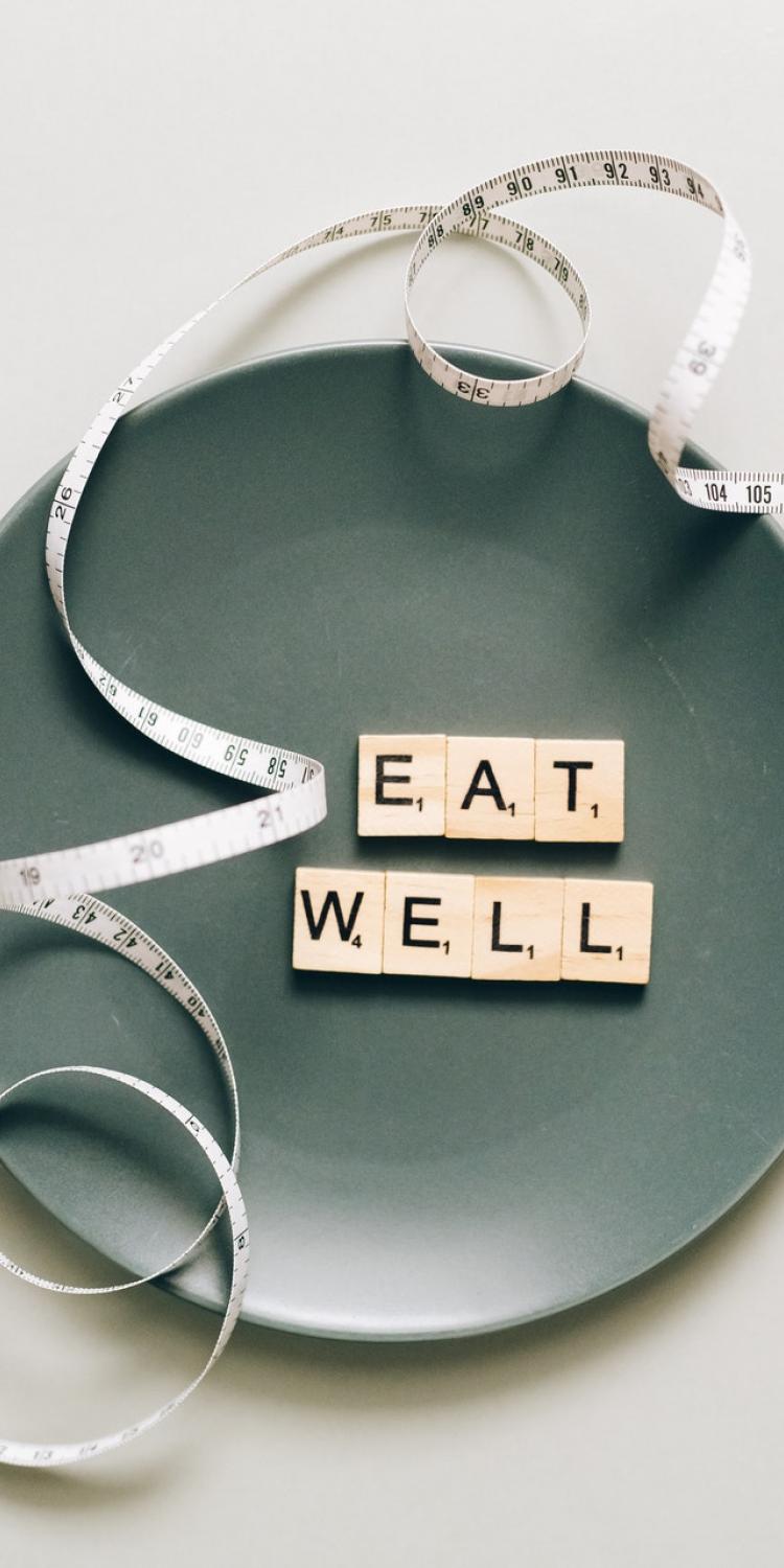 "Eat Well" letters on a plate