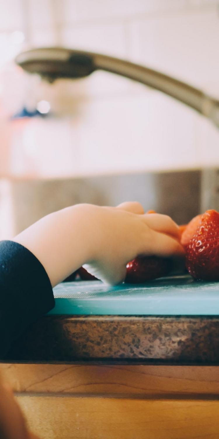 Child grabbing strawberry