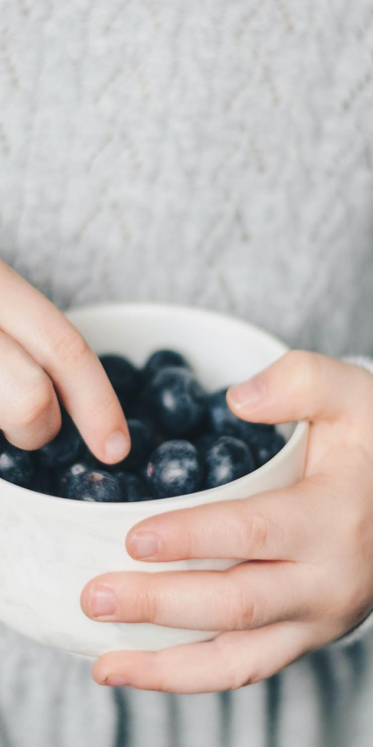 Child eating blueberries