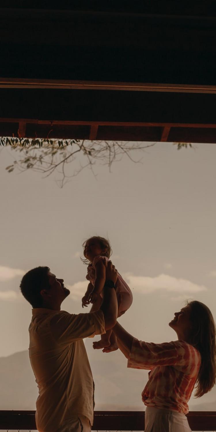 Parents holding their baby up