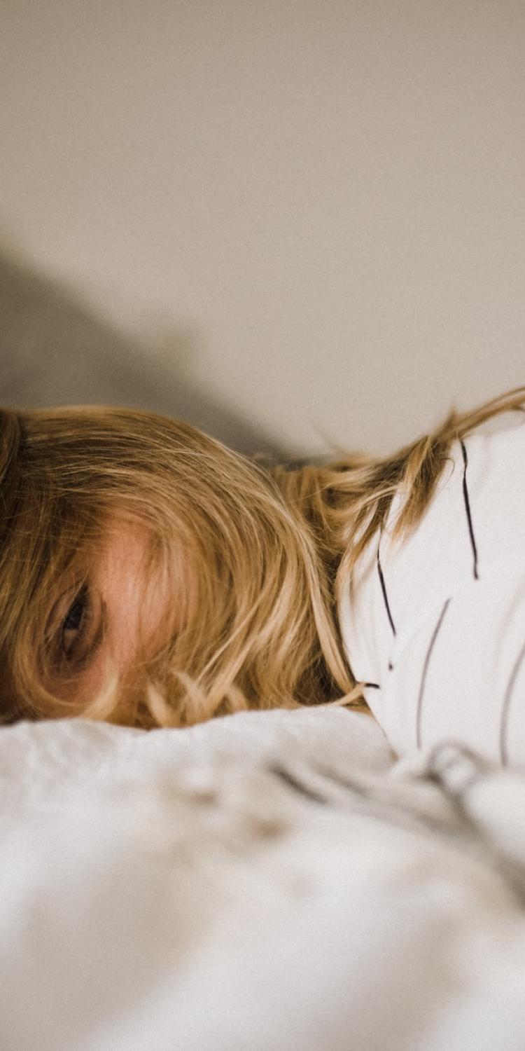 Woman lying on bed
